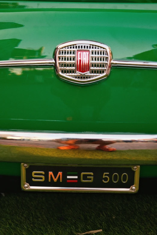 the grille of a vintage mercedes car parked on a street