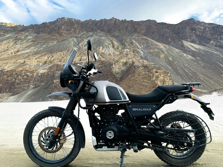 a black motorcycle parked on a desert road