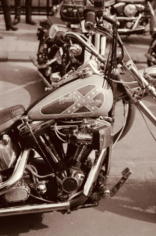 a close up of an antique motorcycle parked on the side of the street