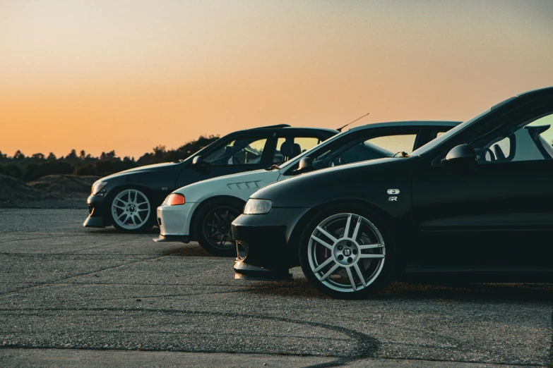 three cars lined up parked near one another