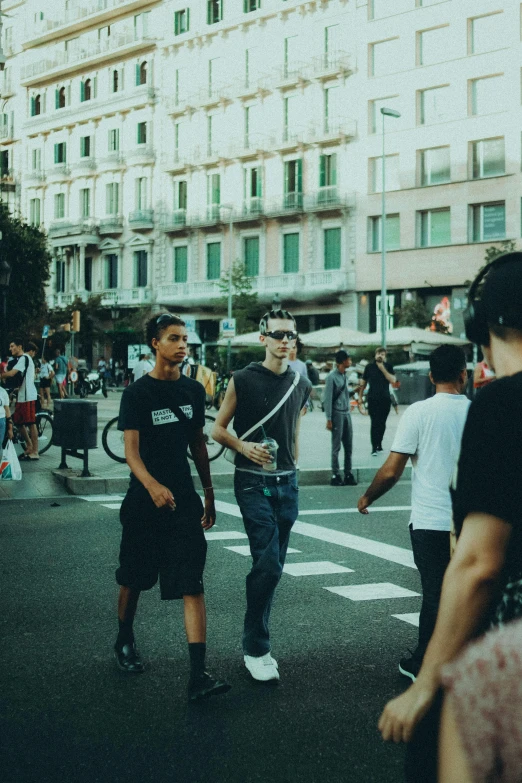 two boys are talking in the middle of an urban street