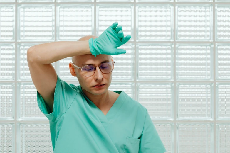 man in green shirt with blue gloves on