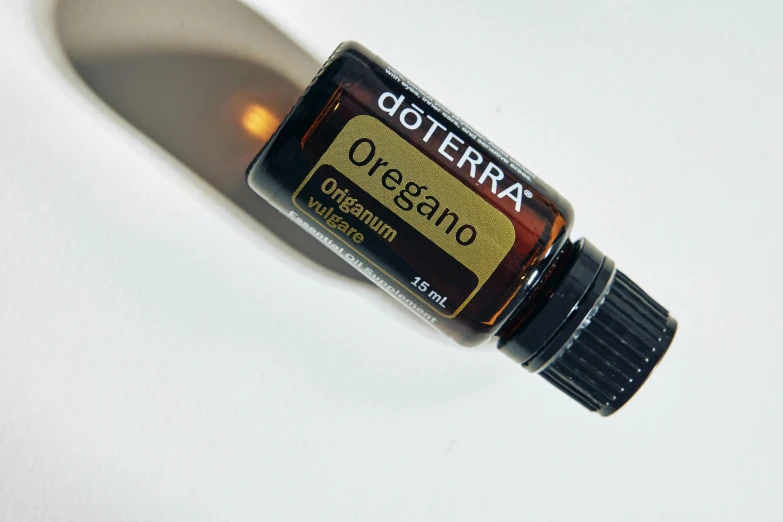 a bottle of doterra essentials vitamin oil on a white background