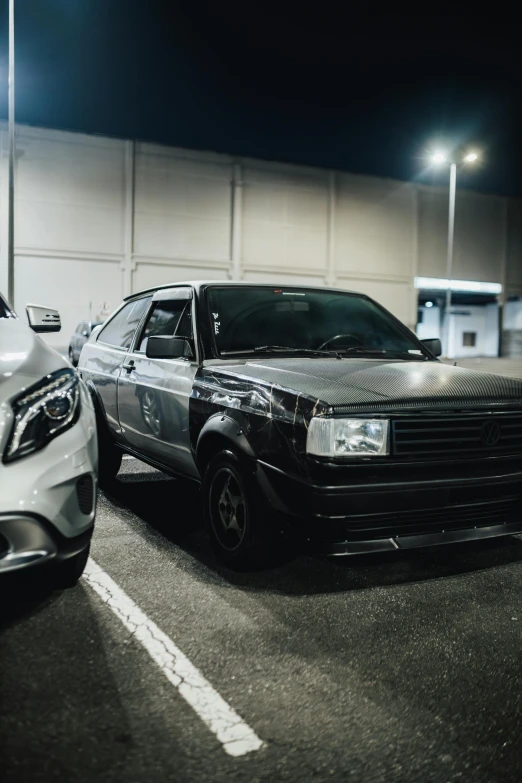 several cars parked on a lot at night