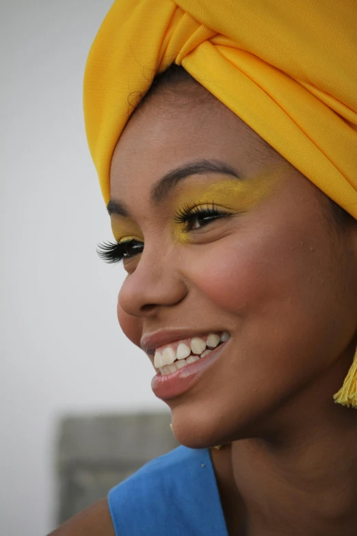 a  with yellow turban smiles and poses