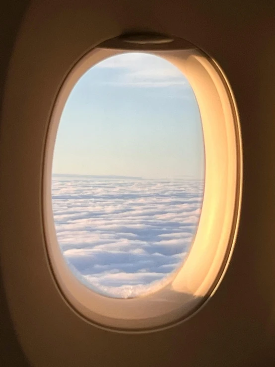 the wing of an airplane flying above the clouds