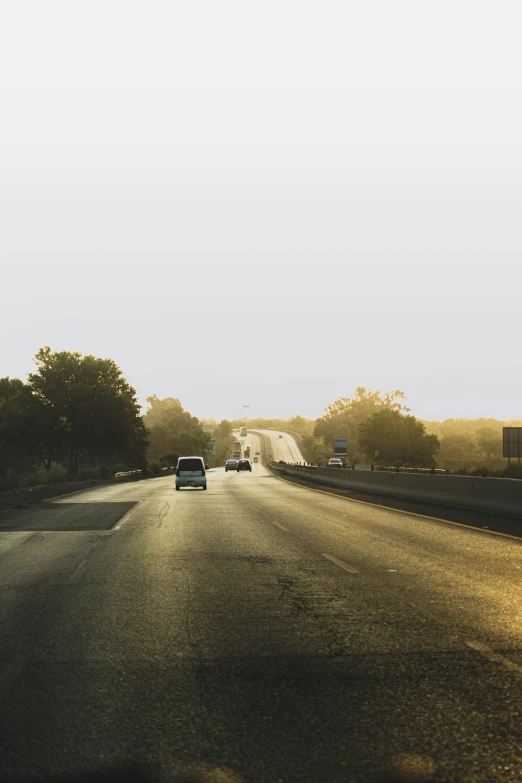 cars drive down a highway on a clear day