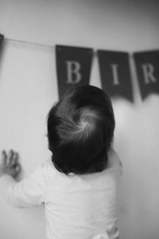 a baby stands in the corner of the room