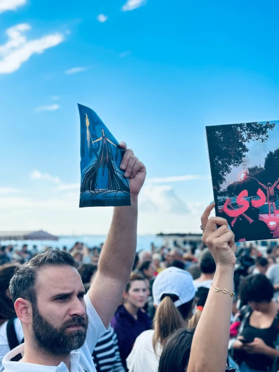 people holding posters in protest for the release of a book