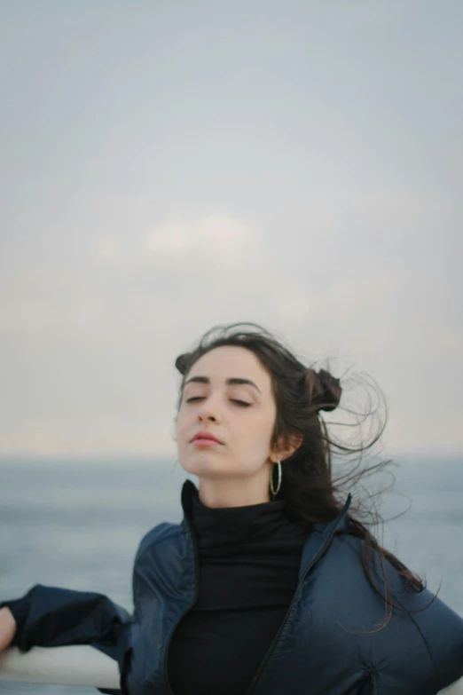 the woman is standing alone by the ocean