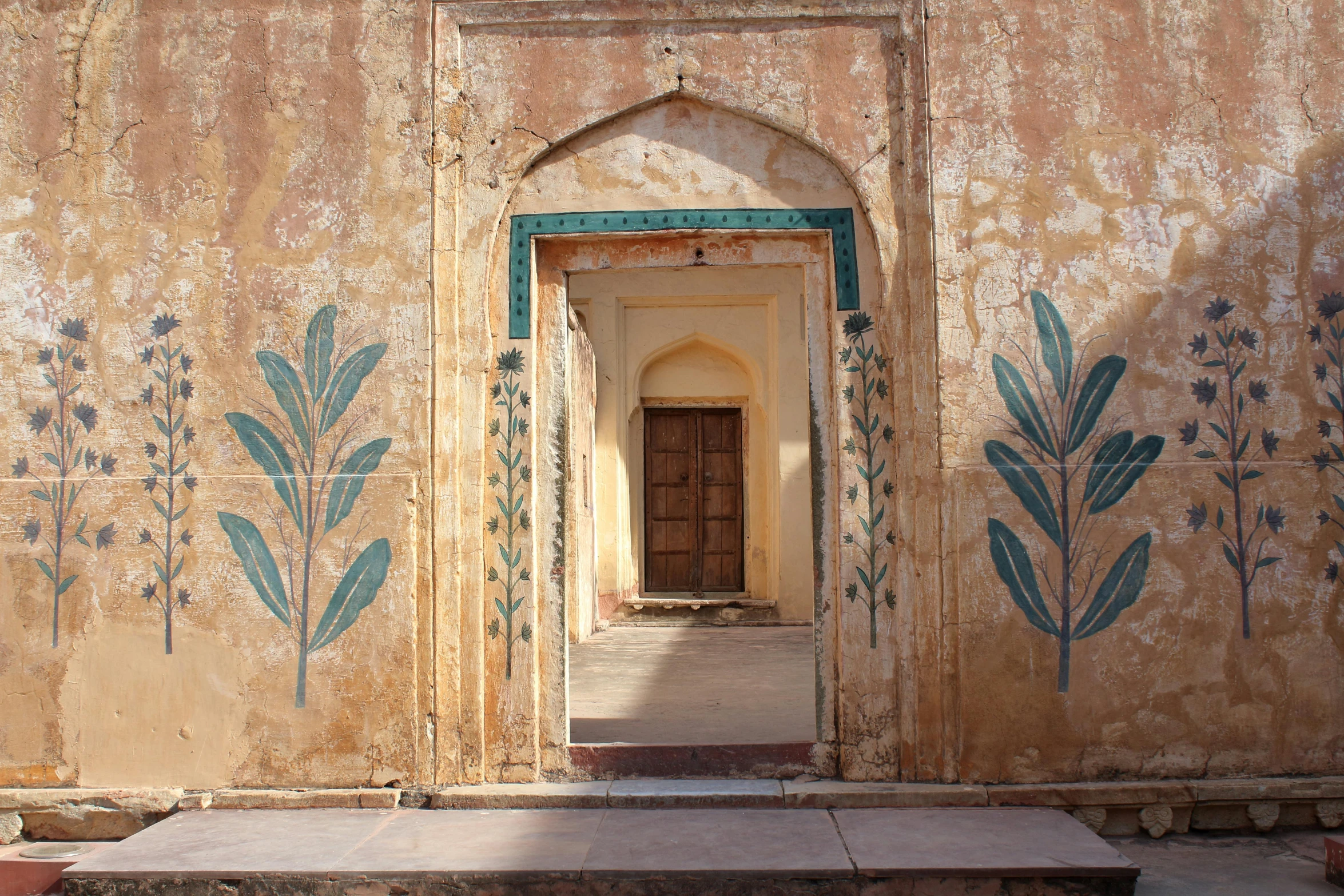 the wall has a doorway, and it is made of brick