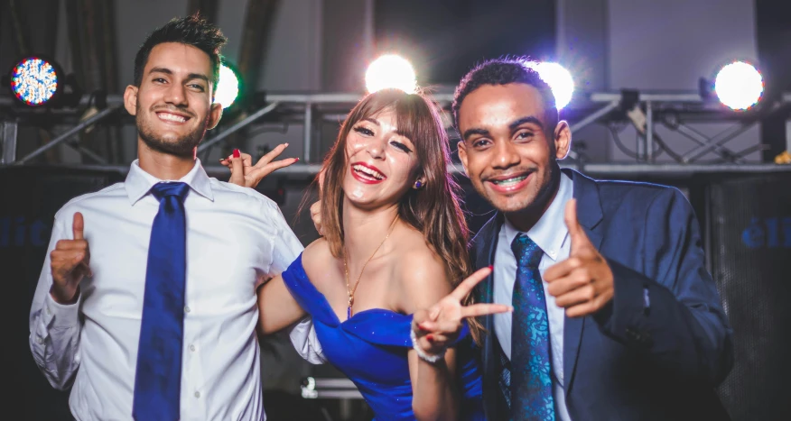 two men and a woman posing for a po