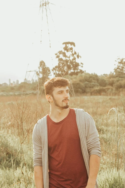 man with open eyes standing in a field