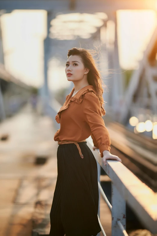 a woman standing on top of a street next to a metal fence