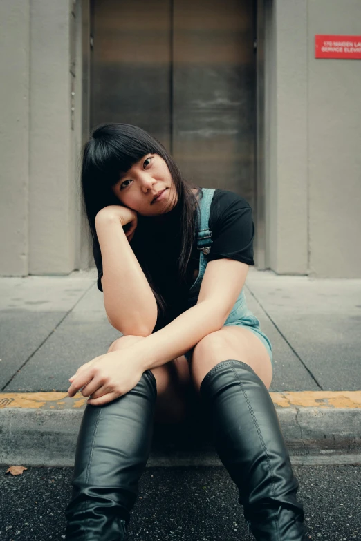 a woman sitting on the curb looking unhappy