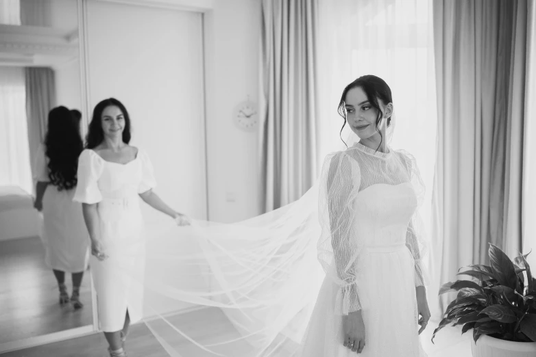the bride is posing for her picture with her mom