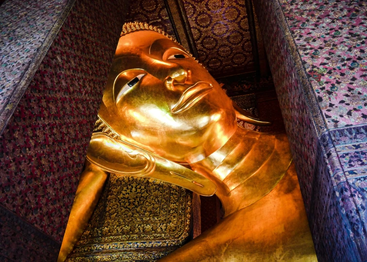 a golden buddha statue in the corner of a room