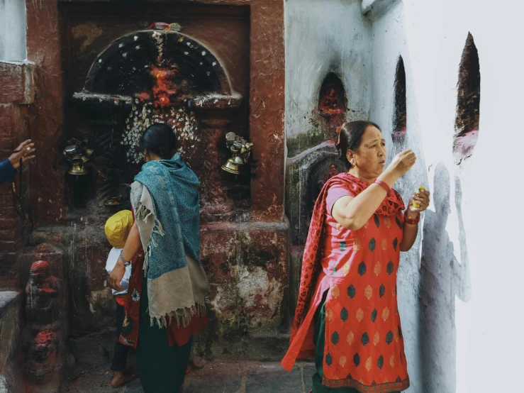 a woman standing in front of a building holding a hand