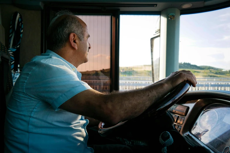 a man who is driving his vehicle along the water