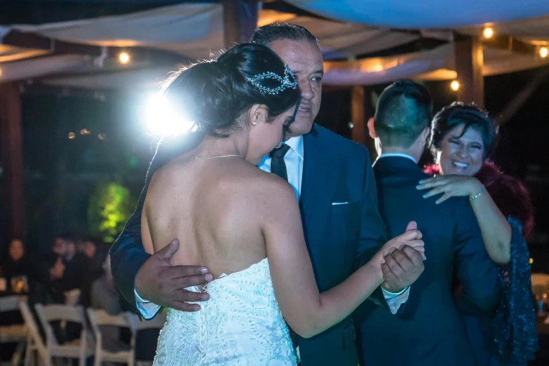 a bride and groom dance together on the dance floor