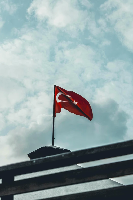 a flag flying over some metal bars