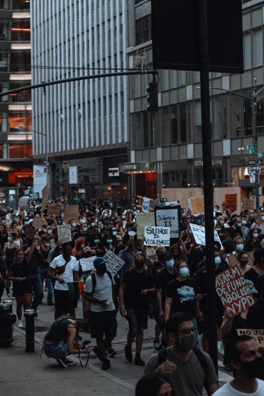 a large group of people walking down the street