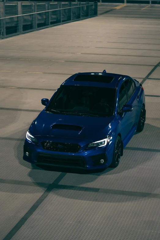 the blue sports car is driving on a race track