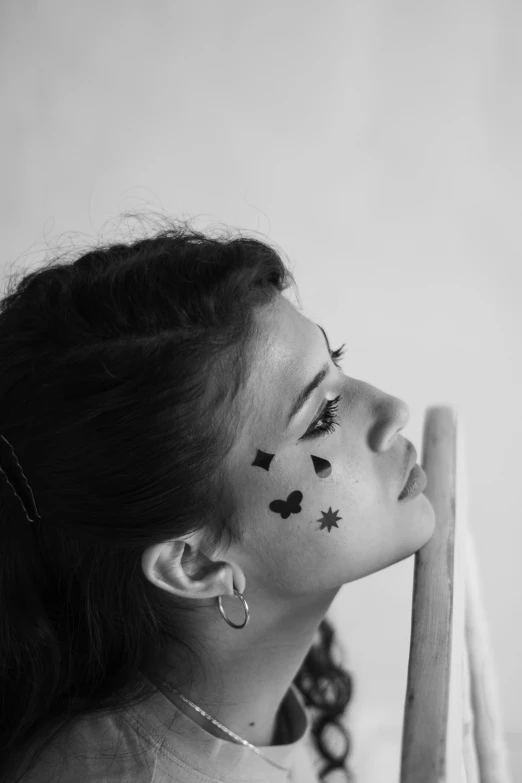 a woman with erflies painted on her face posing for a picture