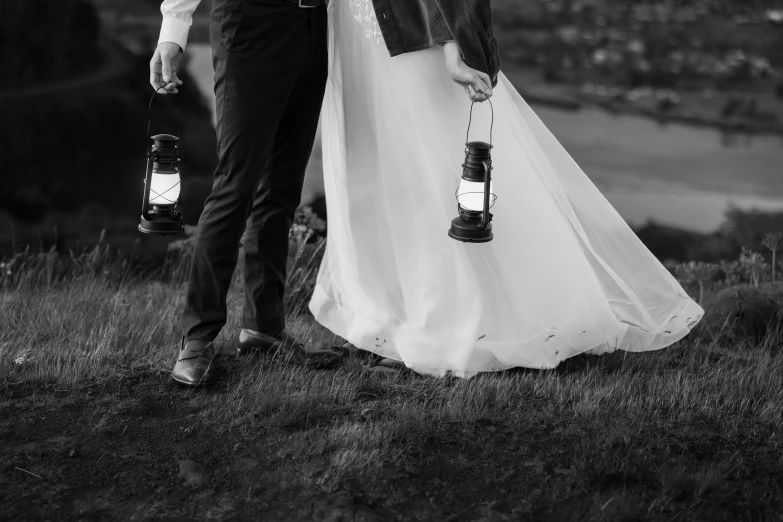 a newly married couple holds each other in the field