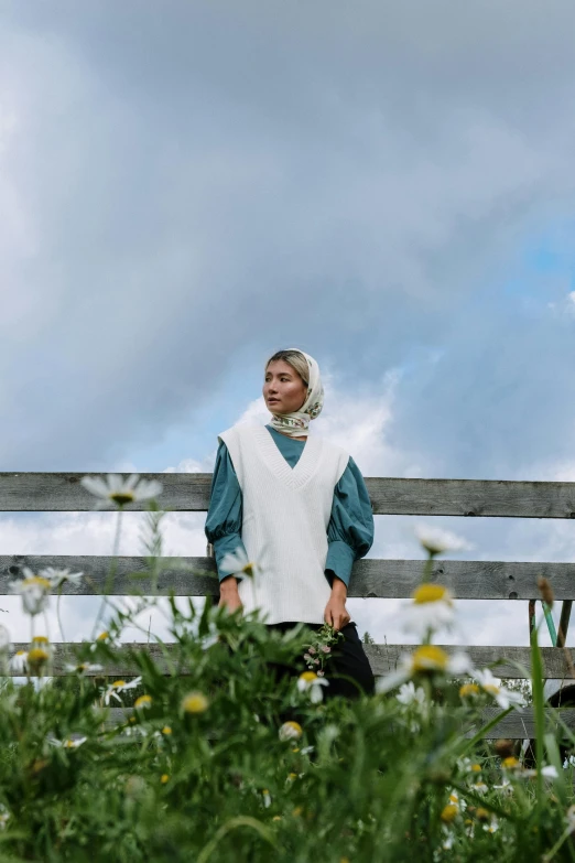 a woman standing on top of a lush green field