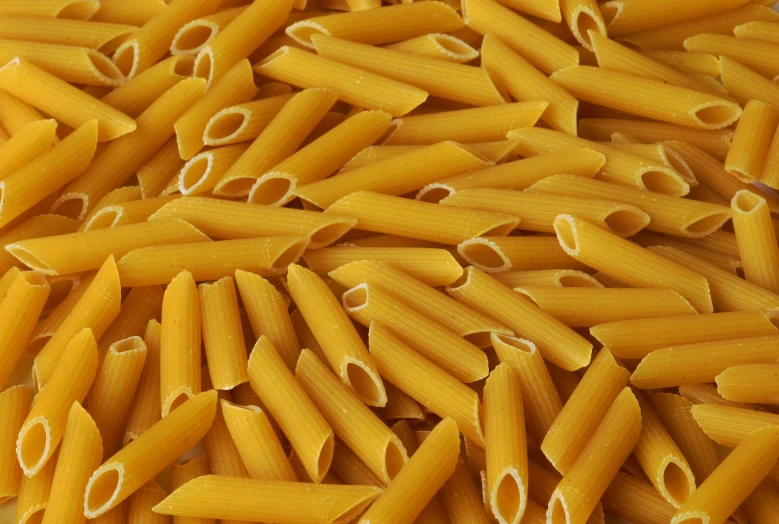 yellow noodles laid out in rows on a table