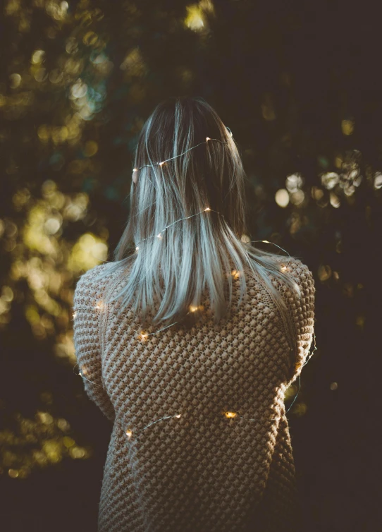 a woman with light hair walking alone