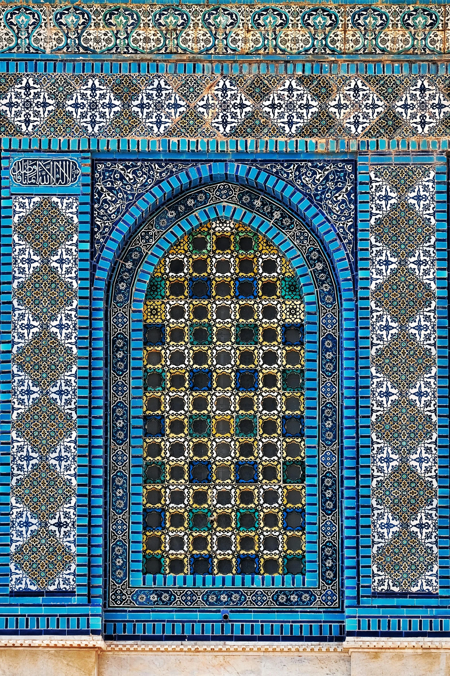 an architectural view from a building with geometric shapes and a blue - tiled entrance