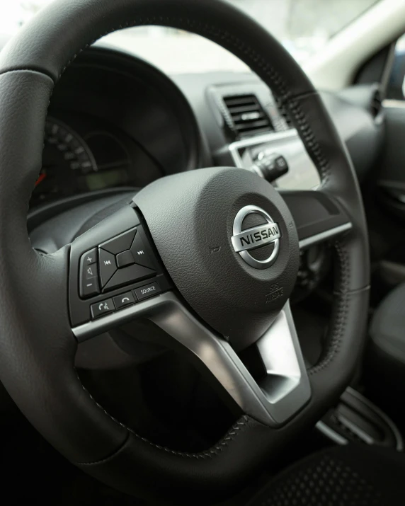 a steering wheel and dashboard of a small car