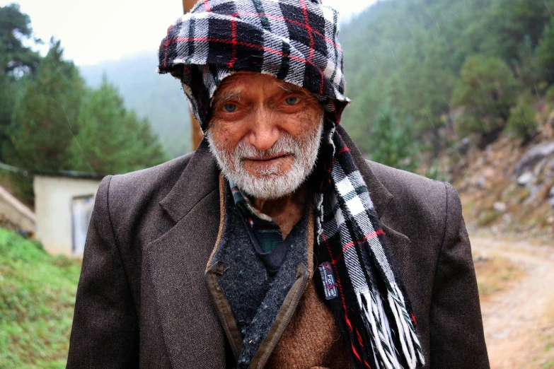 an older man with a plaid cap on