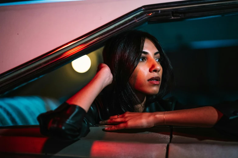 a woman standing in the back seat of a car