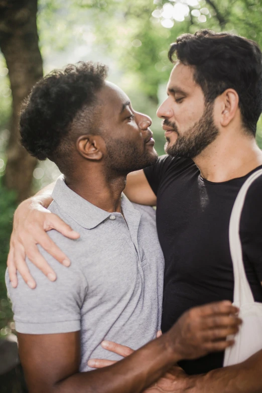 two men hugging each other while smiling together