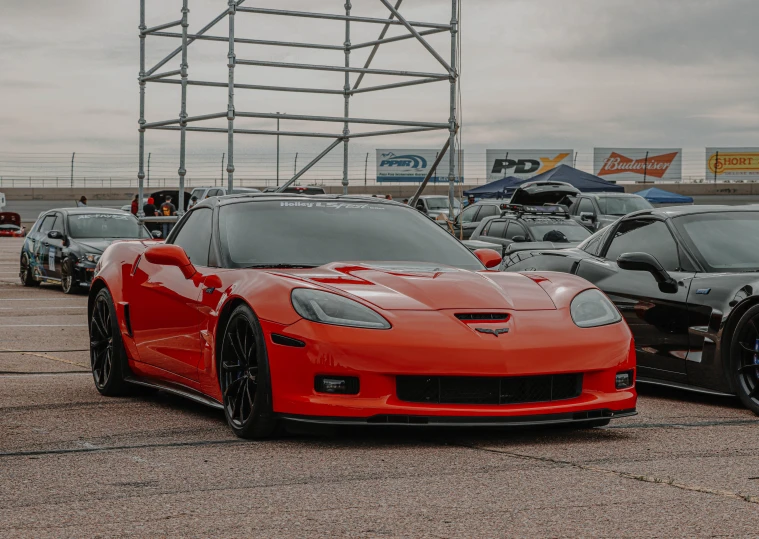 red and black sports cars parked near each other