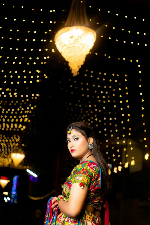 woman in oriental traditional garb posing at night