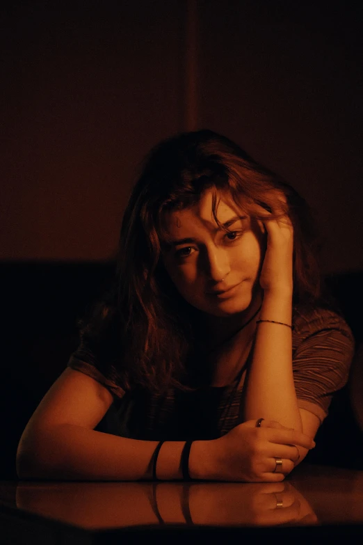 a person sitting at a table in front of a cell phone