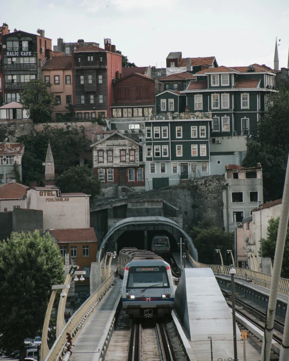 a train traveling over a bridge next to a city