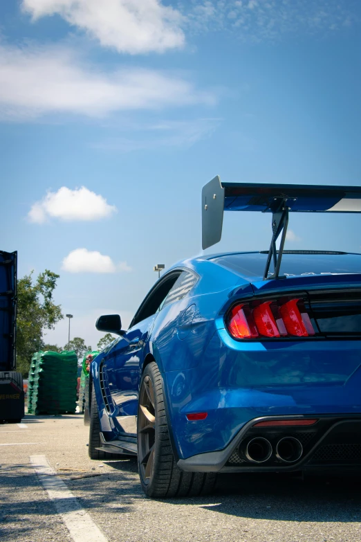 the blue mustang sports car is parked on the road