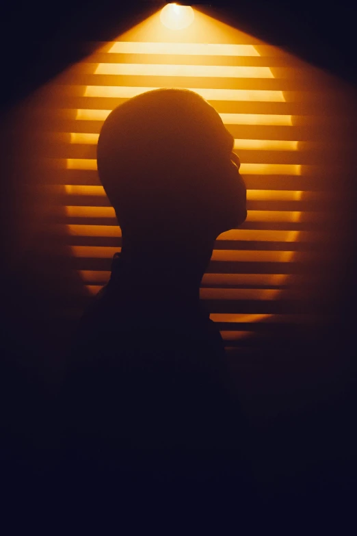 the silhouette of a man at night with light from behind