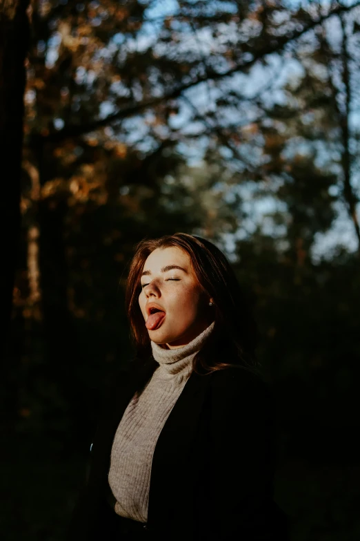 woman making funny face in front of trees