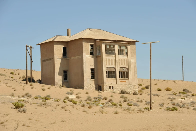 an old house with multiple windows in the desert