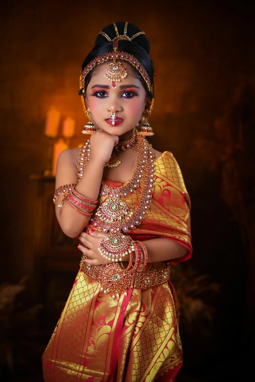 an indian girl in traditional dress, posing for the camera