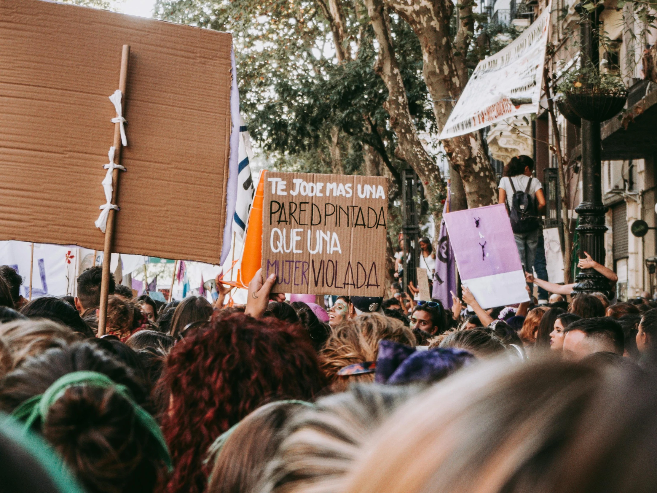 a group of people on stage holding signs and flags