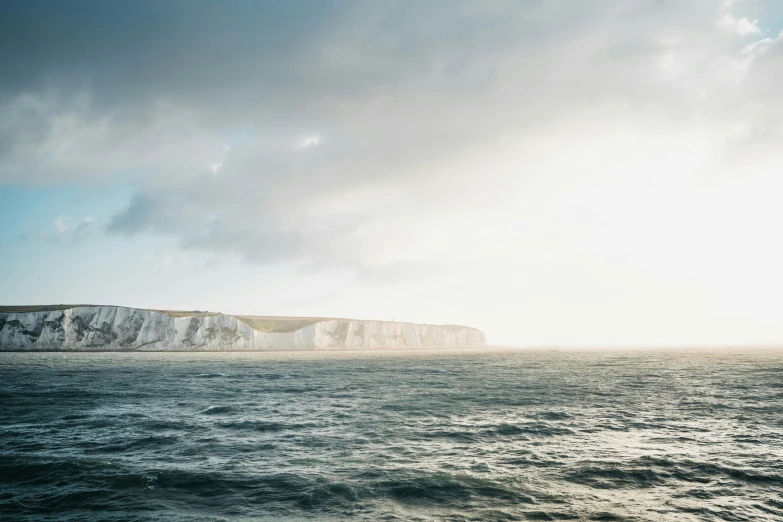 a large body of water near a large cliff