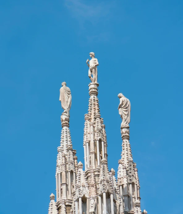 the top part of a church with statues on top