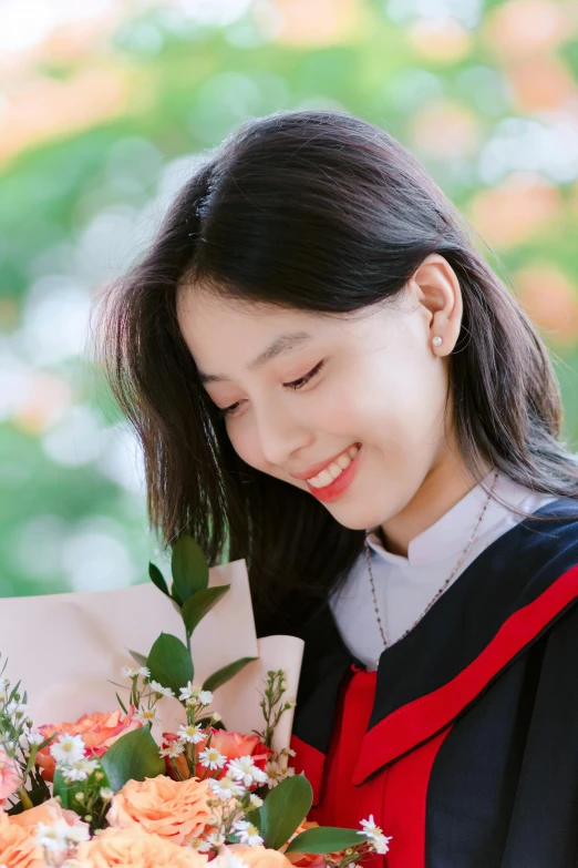 asian woman holding bouquet of flowers near green background